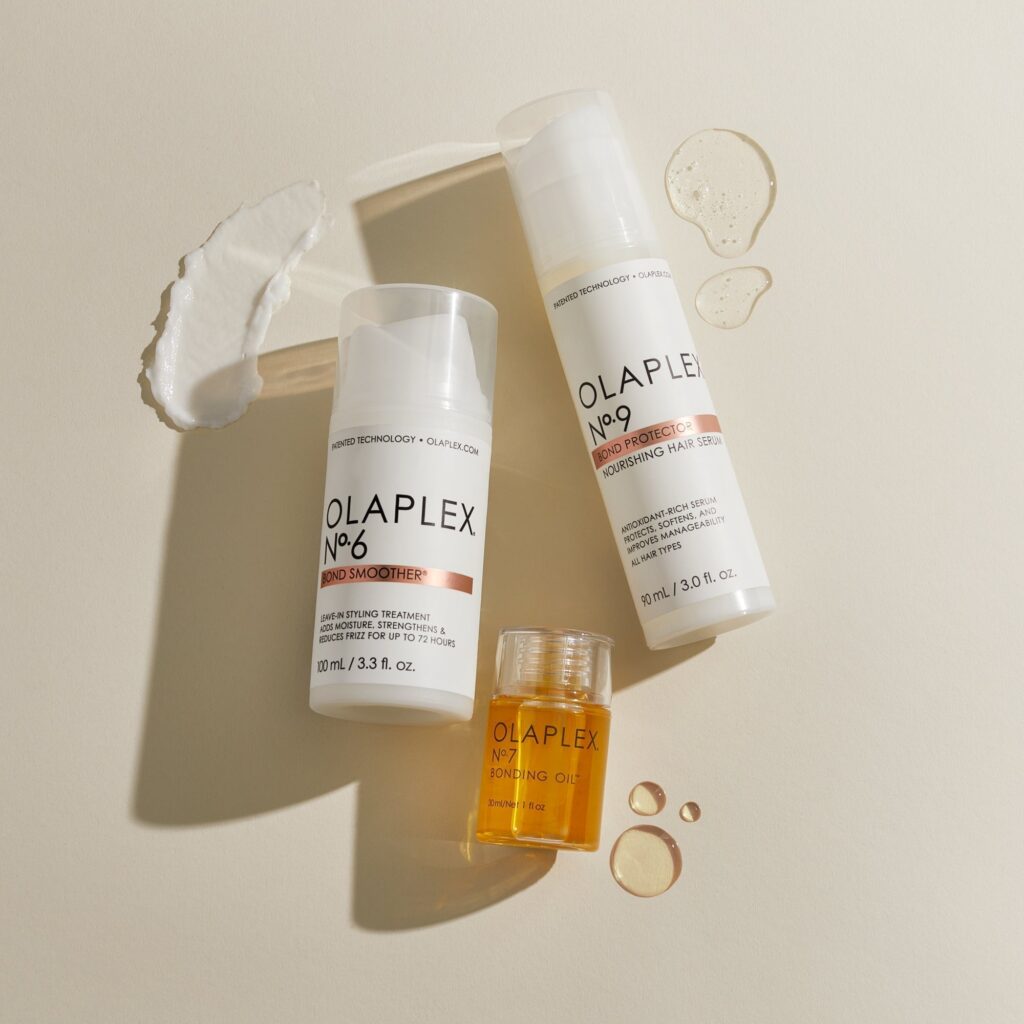 OLAPLEX No.6, No.7, and No.9 next to each other on a cream-colored surface