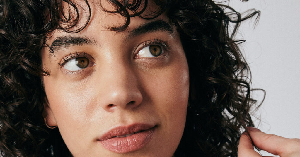 Side profile of a woman with curly hair