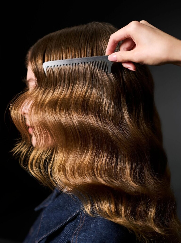 Woman with sleek waves having her hair combed