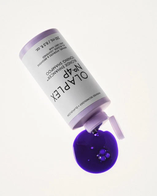 Bottle of No.4P laid on its side with purple shampoo spilling out