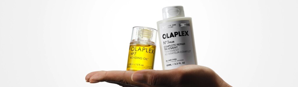 OLAPLEX Nº.3PLUS and Nº.7 Bonding Oil being held in the palm of an outstretched hand